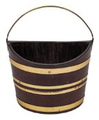 An 18th Century mahogany and brass bound navette-shaped bucket:, with brass swing handle, 47.