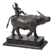 A South East Asian bronze model of an ox: with seated drover on its back,