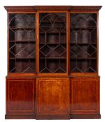 An early 19th Century mahogany and inlaid breakfront library bookcase:, crossbanded in satinwood,