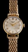 Longines, a gold wristwatch,: the dial with baton markers and tapered baton hands,