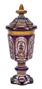 A Bohemian purple and clear overlay glass goblet and cover: of hexagonal form with pointed finial