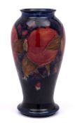 A William Moorcroft baluster vase: tube-lined and decorated in the 'Pomegranate' design,