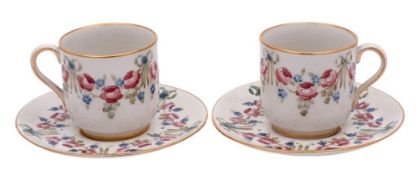 A pair of William Moorcroft Macintyre Florian ware cups and saucers: decorated in the 'Eighteenth