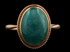 A 9 carat gold aventurine quartz ring,: the oval cabochon aventurine quartz in a collet setting,