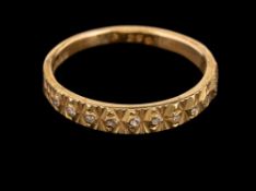 A 1970s 18 carat gold and diamond ring,: the half textured band set with eight cut diamonds,