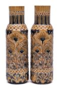A pair of William Moorcroft Florian ware vases: of cylindrical form,