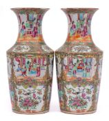 A pair of Chinese Canton famille rose vases: with waisted necks and flared rims,