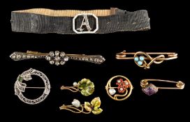 A moire strap with enamelled and diamond-set initial 'A' buckle and with seven attached brooches: