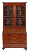 A George III mahogany bureau bookcase:, the associated upper part with a moulded cornice,