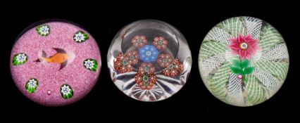 Three Perthshire paperweights: comprising a pink double Clematis set on an radial swirl formed from