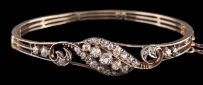A diamond bangle,: the hinged bangle with a scrolled panel set with old cut diamonds,