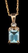 An aquamarine and diamond pendant,: the rectangular cut aquamarine in a four claw setting,