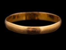 A 22 carat gold ring,: the polished band stamped 22 with full Birmingham hallmarks for 1960,