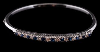 An 18 carat gold sapphire and diamond bangle,