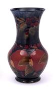A William Moorcroft vase: of baluster form with waisted neck and flared rim,