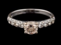 A diamond ring,: the central brilliant cut diamond, estimated to weigh 0.