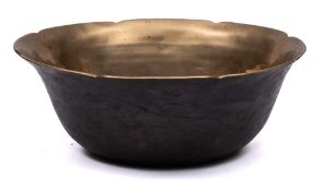An oriental bronze bowl: of plain circular form with wavy edge border, 18cm diameter.