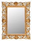 A carved giltwood Florentine frame mirror:, of rectangular shape,