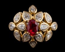 A ruby and diamond ring by Cartier,: the central oval cut ruby estimated to weigh 1.