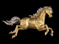 An 18 carat gold diamond horse brooch,: the horse set with eight cut diamonds to the forelock,