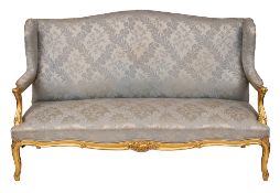 A pair of carved and giltwood and silk damask upholstered canapés in Louis XV taste,