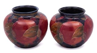 A pair of William Moorcroft miniature vases: of globular form,