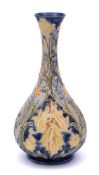 A William Moorcroft Florian ware bottle vase: tube-lined and decorated in the 'Iris' design with