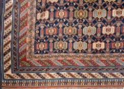 A Shirvan carpet:, the indigo field with an all over geometric design,