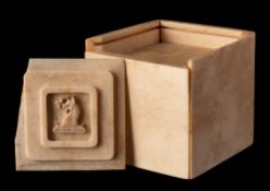 A 19th century ivory tangram (puzzle box): of square outline containing assorted sections,