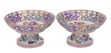 A pair of Meissen [outside decorated] reticulated tazze: the pedestals moulded with ribbon tied