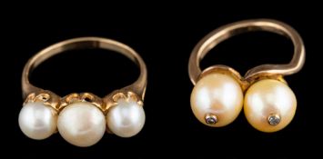 A cultured pearl and diamond-set crossover ring,: each cultured pearl set with a single diamond,