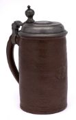 An early 18th century German pewter-mounted brown stoneware cylindrical tankard and a 19th century