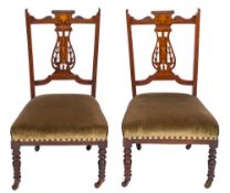 A pair of Edwardian rosewood and marquetry nursing chairs:,
