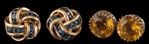 A pair of 9 carat gold sapphire earrings,: the knotted panels set with circular cut sapphires,