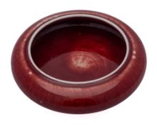 A small Chinese copper red glazed brush washer: of compressed bombe form, 12cm.