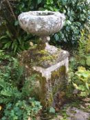 A carved stone pedestal garden urn:,