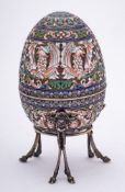 A late 20th century silver gilt and champlevé enamel Easter egg in the Imperial Russian style: