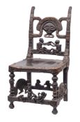 A Tchokwe tribe (Angola) chief's chair: the high back with carved mask and figural decoration,