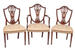 A set of six 19th Century carved mahogany dining chairs in the Hepplewhite taste:,