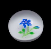 A Baccarat flower paperweight: set with a blue double flower and bud on a sodden snow ground set