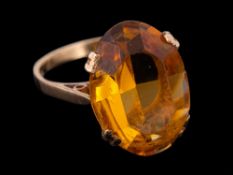 A 9 carat gold fire opal ring,: the oval cut fire opal in a claw setting,