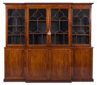 An early 19th Century mahogany breakfront library bookcase:, the upper part with a moulded cornice,