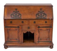 An Arts and Crafts oak bureau, circa 1900,: with retail plaque for P.E.
