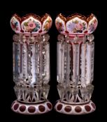 A pair of Bohemian red and white overlay glass table lustres: of traditional coronet form decorated