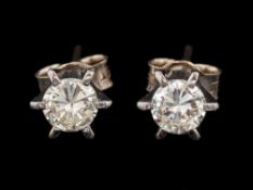 A pair of diamond ear studs,: each set with a brilliant cut diamond, approximately 0.
