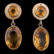 A pair of citrine earrings: each set with a circular cut citrine suspending an oval cut citrine