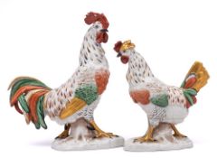 A pair of Continental 'gold anchor' figures of a cock and hen: with red, green and gilt plumage,