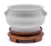 A Chinese Dehua blanc de Chine censer: of compressed bombe form with Buddhistic lion dog handles,