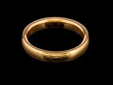 A 22 carat gold ring,: the plain polished band, stamped 22 with full Birmingham hallmarks,