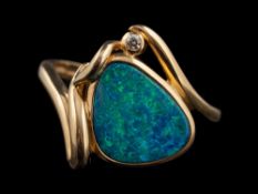 A 14 carat gold boulder opal and diamond ring,: the pear shaped boulder opal in a collet setting,
